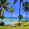 Mombasa Kenya beach resort with swimming pool, palm trees, sun loungers, and ocean view